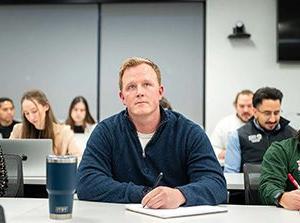 MSU Denver MBA student Jamie McClintock attends class with College of Business professor Paul Anderson. Photo by Josh Geurink